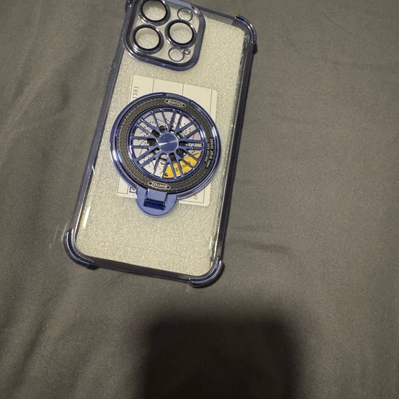 Clear Phone Case with Blue Accents For a 15 Pro Max. Spinning wheel in Center. - Picture 12 of 14